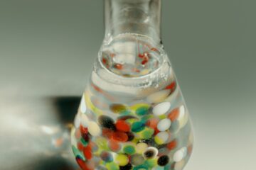 clear glass bottle with multicolored liquid