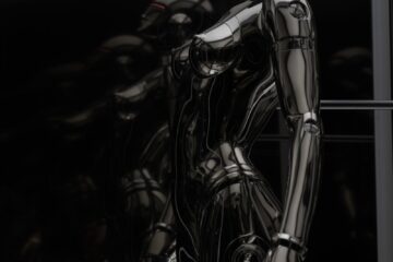 stainless steel robot toy in close up photography