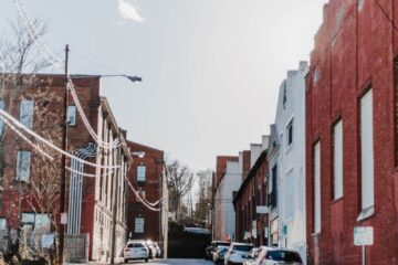 cars parked on road in front of concrete houses