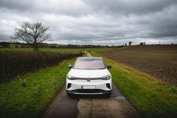 White electric car parked on a rural road