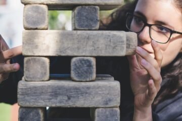 woman playing with wooden blocks