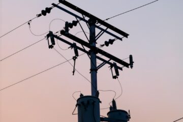 black electricity post under white sky