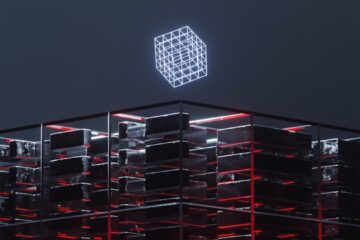a tall building with a neon cube on top of it