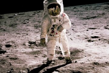 astronaut standing on gray sand