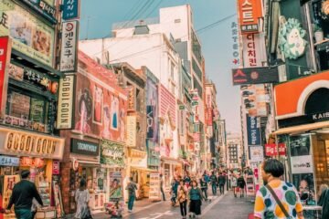 people walking on road surrounded by buildings