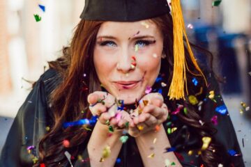 woman blowing assorted color confettis
