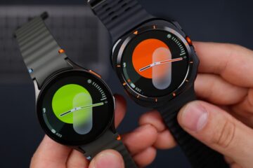 A person holding a smart watch in their hands
