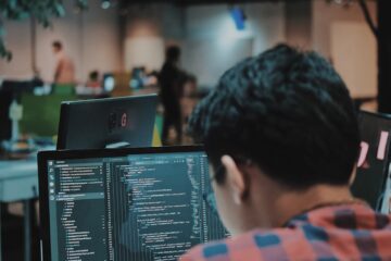 sitting man using gadget in room
