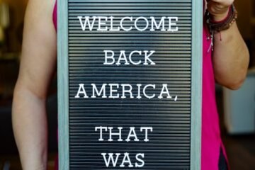 person holding black and white quote board