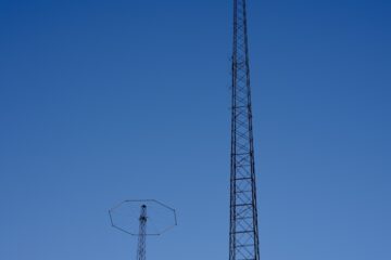 black steel electric post under blue sky during daytime