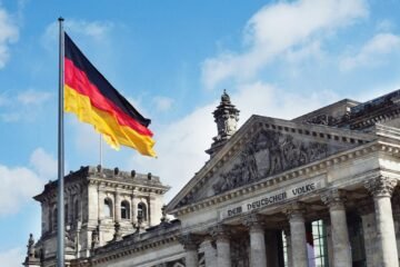 The German flag flying above the Reichstag building in Berlin, Germany