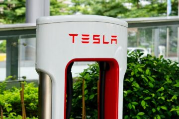 a close up of a red and white tesla charging station