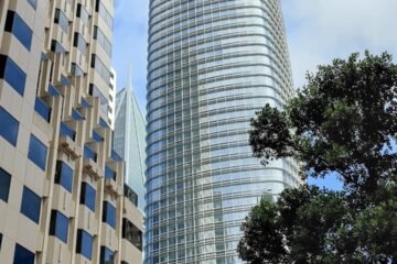 a city street with tall buildings in the background
