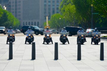 six men riding motorcycles