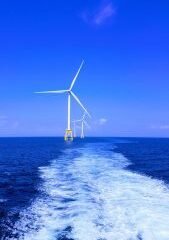 three white wind turbine on sea
