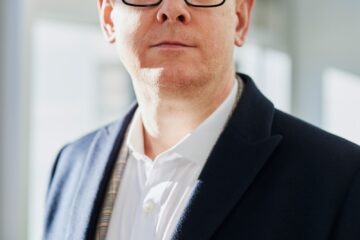 man standing beside wall