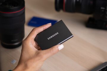 a hand holding a black device