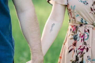 selective focus photography of man and woman holding there hands