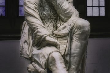 woman in dress statue in grayscale photography