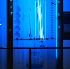 a blue light is shining on a glass case