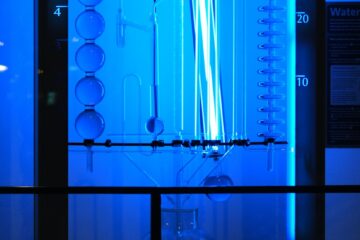 a blue light is shining on a glass case