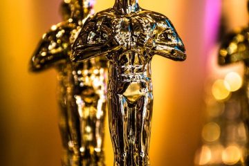 a number of oscar statues on a table