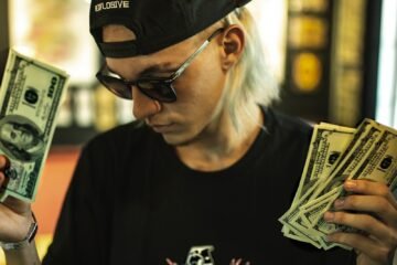man holding US dollar banknotes