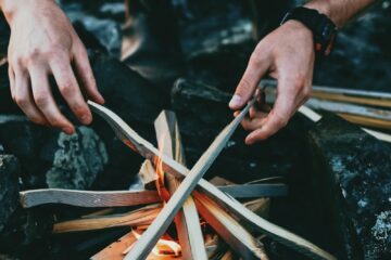 person holding gray wooden wood