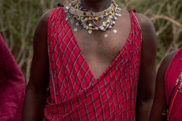 woman in red and black plaid dress wearing silver necklace